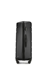 Black hardshell suitcase with textured surface, vertical design, dual zippers, and four swivel wheels for mobility. Side handle included.
