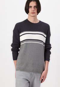 Gray ribbed knit sweater with dark gray and white horizontal stripes, round neckline, and long sleeves, featuring a textured design.