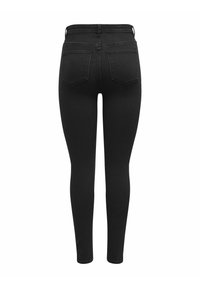 Jeans skinny de mezclilla negra con una cintura alta, que presentan dos bolsillos traseros y una textura suave en toda su superficie.