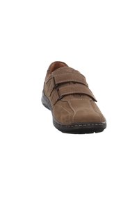 Brown suede shoe with two adjustable Velcro straps, detailed stitching, and a black rubber sole, featuring a rounded toe design.