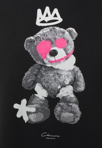 Grafica di un orsetto grigio su uno sfondo nero, con una corona sopra e dettagli rosa sugli occhi e sulla bocca. Design semplice e audace.