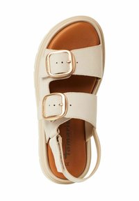 Beige leather sandal with two gold buckles, brown cushioned insole, and a thick white sole. Features an open design and ankle strap.