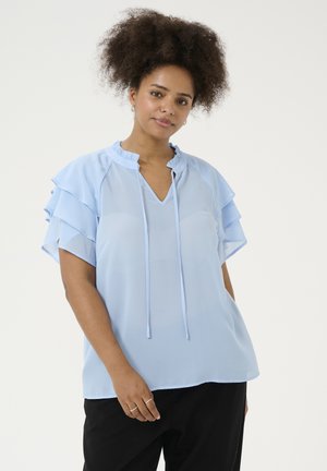 Light blue blouse features a V-neck, ruffled sleeves, and drawstring detail. Made of a sheer fabric with a loose fit.