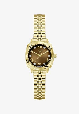 Kuldne metallist käekell pruunika sihverplaadiga, rooma numbritega, teemanttunnimärkidega ja kolme kulla käega, mis näitavad aega 10:12:36.