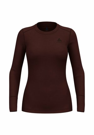 Brown long-sleeve thermal top made of smooth, stretchy fabric. Features a round neckline and flat seams with a subtle logo on the chest.