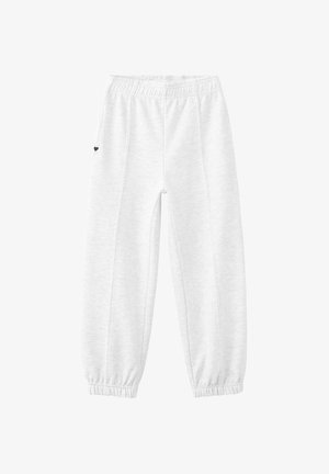 Pantalon de survêtement blanc avec une ceinture élastique et des poignets. Texture lisse avec un petit détail en forme de cœur noir sur la cuisse gauche.