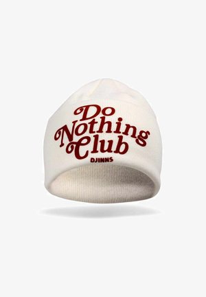 White knit beanie with rolled brim, featuring red text that reads "Do Nothing Club." Marked with "DJINNS" logo near the brim.
