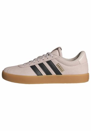Light pink suede sneaker with black stripes, rounded toe, and gum rubber sole. Features lace-up closure and Adidas branding on side.