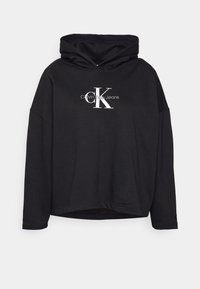 Felpa nera con cappuccio in morbido tessuto, con logo bianco Calvin Klein Jeans sul davanti. Maniche lunghe e design corto.