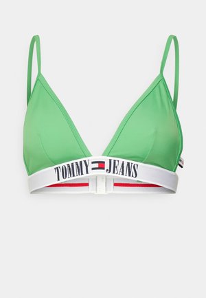 Zelená trojúhelníková podprsenka vyrobená z hladké látky. Obsahuje bílý elastický pásek s červenými a modrými akcenty a značkování "TOMMY JEANS". Nastavitelné ramínka.