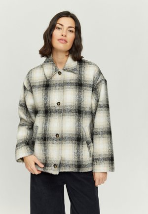 Plaid jacket in beige, black, and gray. Made of soft fabric, featuring a collar, button front, and prominent checkered pattern.