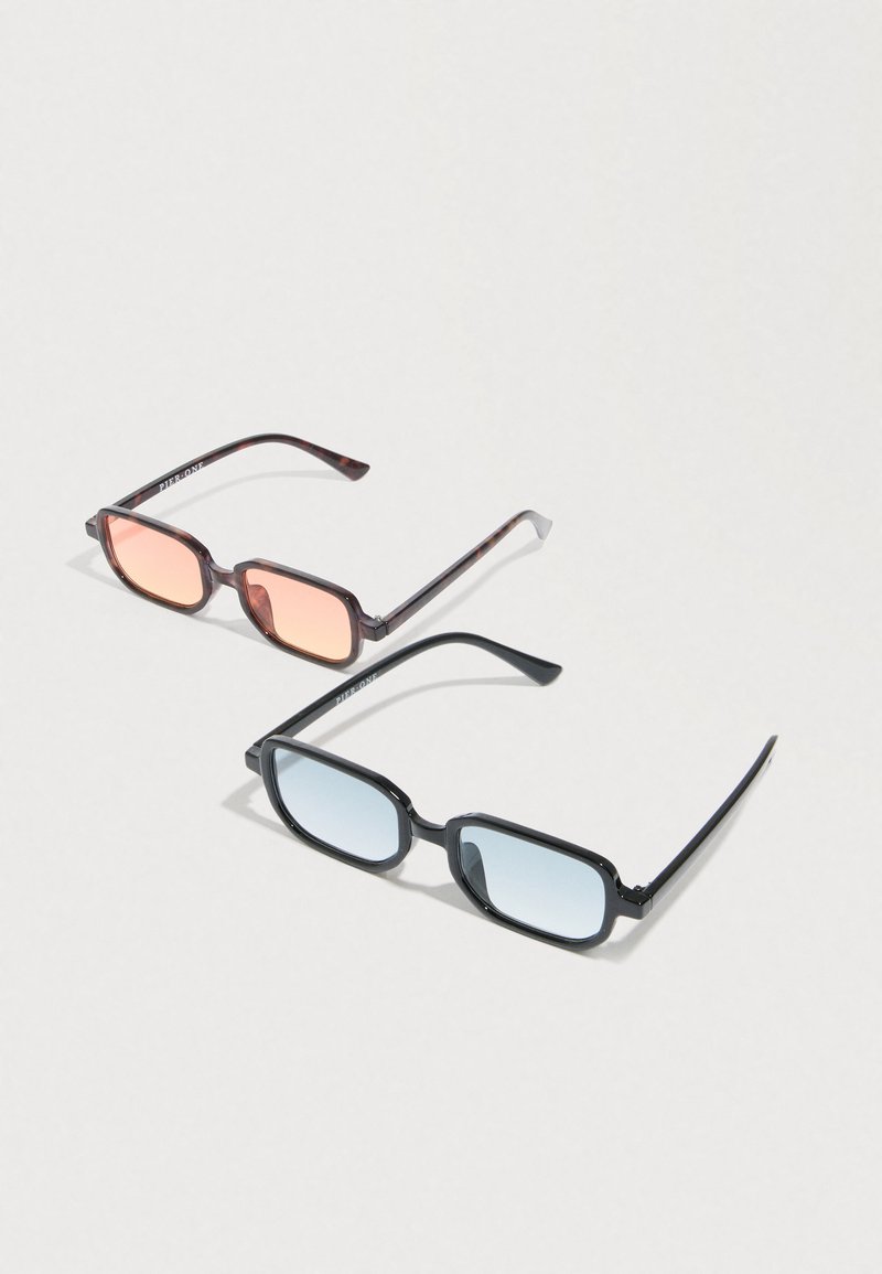 Two pairs of rectangular sunglasses, one with tortoiseshell frame and orange lenses, the other with black frame and blue lenses, on a white surface.
