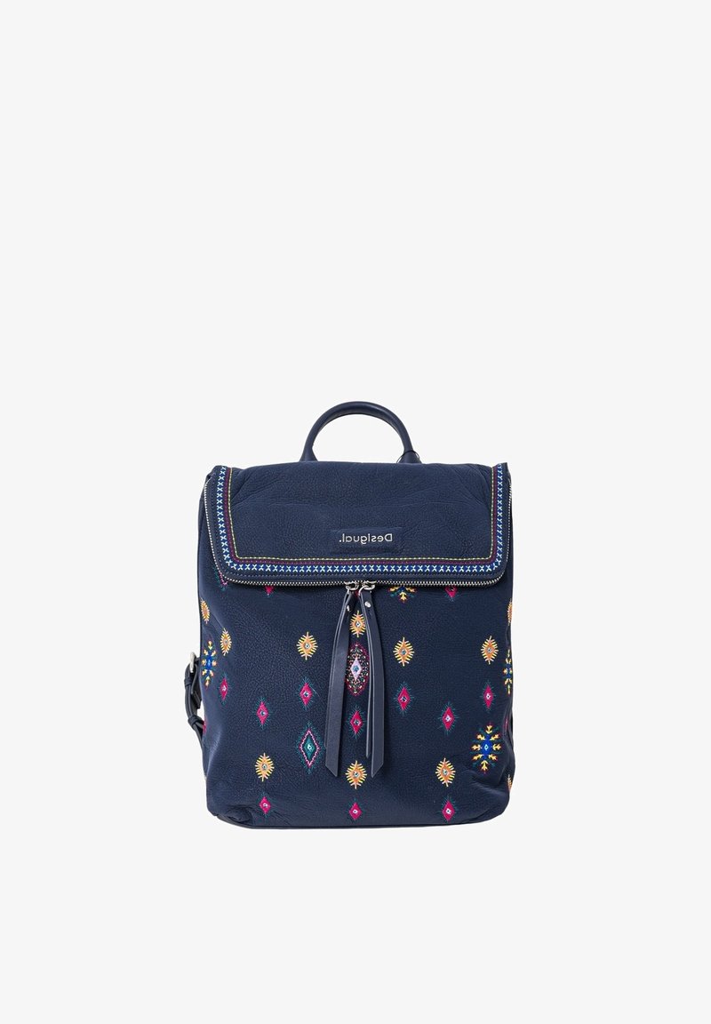 Sac à dos bleu marine avec des motifs colorés de diamants et de soleils, des pompons aux fermetures éclair, une poignée supérieure et un rabat avant portant l'inscription « Desigual ».