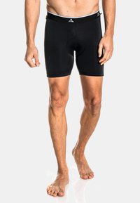 Pantalones cortos deportivos negros con una tela elástica, diseño ajustado y una cinturilla ancha de elastano con un logo en contraste.