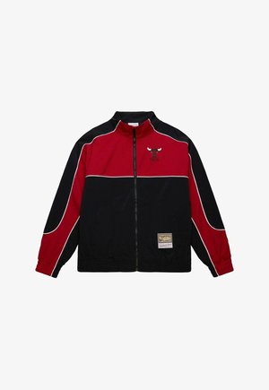 Red and black zip-up jacket, featuring a high collar, white accents, an embroidered logo, and elastic cuffs. Made of smooth fabric.