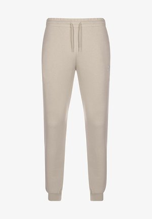 Beige Jogginghosen mit elastischem Bund und Kordelzug. Mit gerippten Knöcheln und einem dezenten Logo an der Seite. Aus weichem Baumwollmischgewebe.