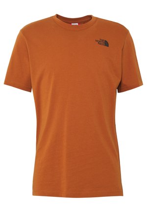 Lyhythihainen ruosteenoranssi pyöreäkauluksinen t-paita, jossa pieni musta "The North Face"-logo ylävasemmalla rinnassa.