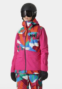 Kleurige skijas met een mix van roze, oranje, groene en blauwe patronen, gemaakt van duurzaam materiaal, met een hoge kraag en ritssluiting.