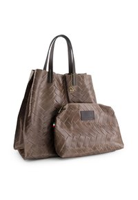 Brown tote bag and matching pouch in textured material, featuring a woven pattern, dual leather handles, and a logo patch on the pouch.