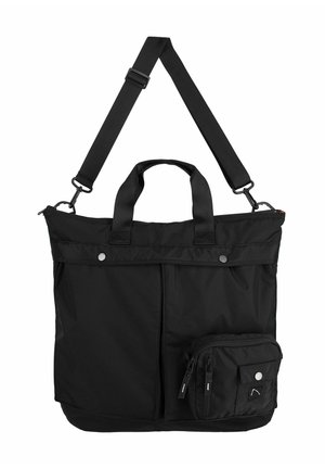 Black tote bag with adjustable strap, dual handles, front zip pocket, smooth texture, and snap buttons. Compact design with additional side pouch.