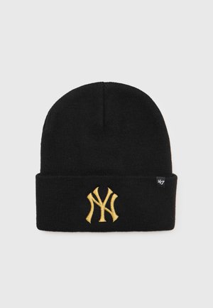 Gorro de punto negro con un dobladillo, que presenta un logotipo bordado amarillo de los New York Yankees en la parte delantera y una pequeña etiqueta de 47 en el lateral.
