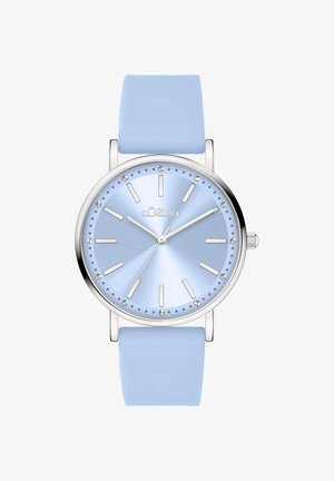 Orologio in silicone blu con cassa argentata, quadrante sfumato blu, dettagli simili a diamanti e indici orari argentati. Quadrante rotondo dal design minimalista.