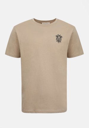 Μπεζ κοντομάνικο T-shirt με στρογγυλή λαιμόκοψη και μικρό μαύρο λουλουδάτο σχέδιο στην αριστερή πλευρά του στήθους.