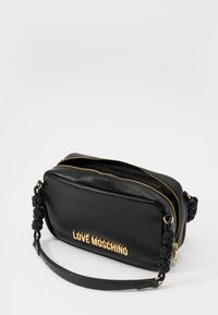 Black leather crossbody bag with a textured braided strap, gold hardware, and "LOVE MOSCHINO" logo in bold letters on the front.