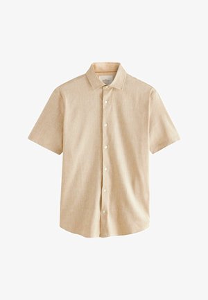 Camicetta a maniche corte di un beige chiaro, realizzata in tessuto tessuto, con colletto e chiusura frontale con bottoni bianchi.