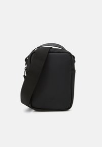 Borsa a tracolla nera realizzata in materiale impermeabile, con forma rettangolare, tracolla regolabile e design minimalista con dettaglio del logo.