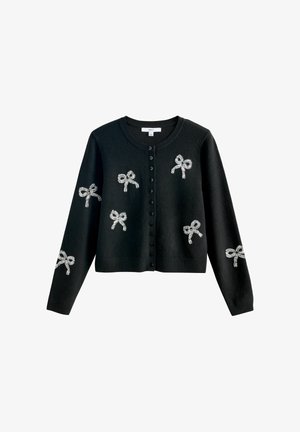 Black button-up cardigan with long sleeves, decorated with silver bow-shaped embellishments on front and sleeves.