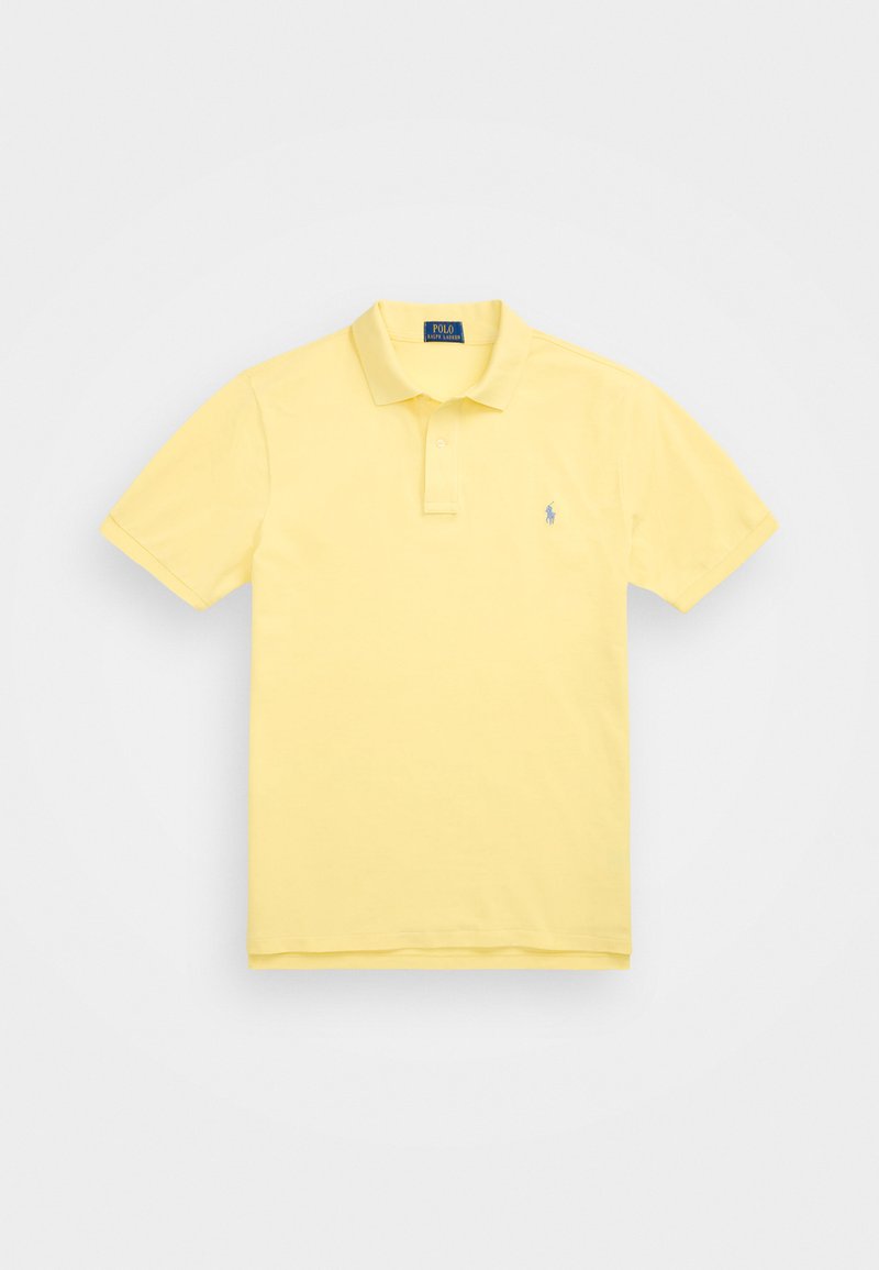 Rumena polo majica iz bombaža, s klasičnim ovratnikom, kratkimi rokavi in majhnim logotipom na levi strani prsnega koša.