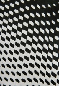 Tessuto in bianco e nero con un motivo geometrico composto da rettangoli arrotondati e rettangoli alternati, disposti in un design a griglia.