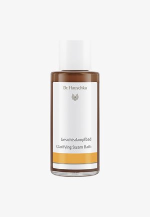 Bouteille en verre brun avec un capuchon et une étiquette blancs. L'étiquette présente un logo, le nom du produit "Gesichtsdampfbad" et une ligne d'accent jaune.