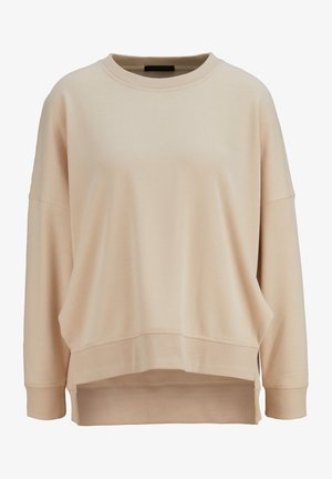 Sudadera de gran tamaño color beige con cuello redondo, hombros caídos y puños acanalados. Presenta un dobladillo asimétrico y una textura suave de mezcla de algodón.