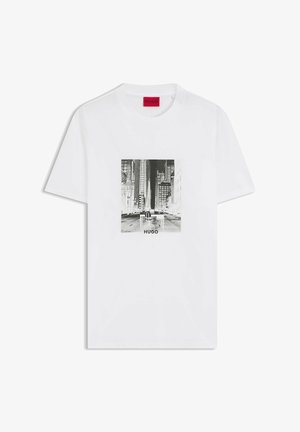 T-shirt bianca in cotone con stampa grafica urbana in bianco e nero sul davanti, con scritta "HUGO" nella parte inferiore. Scollo rotondo, maniche corte.