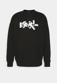 Czarna bluza z długimi rękawami i okrągłym dekoltem, z dużym białym geometrycznym napisem "KARL" na przodzie oraz ściągaczami przy rękawach.
