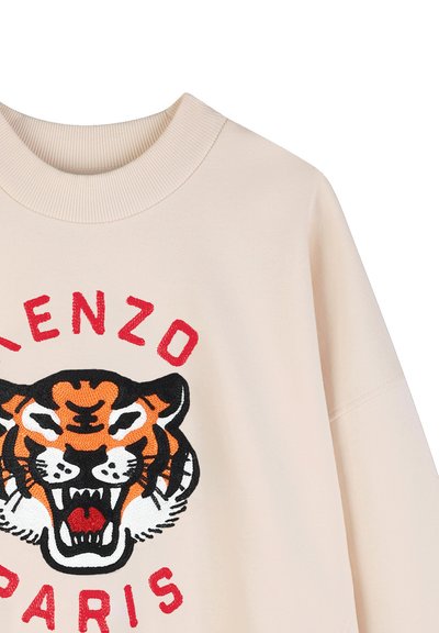 Beige sweatshirt med en fremtrædende broderet tiger grafik i orange og sort, med rød tekst "KENZO" og "PARIS" omkring.