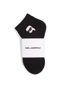 Black ankle sock featuring an embroidered design of a head with sunglasses. The sock is packaged with a branded white label.