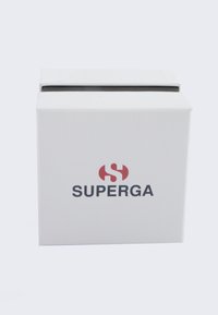White cardboard box with a textured surface, featuring a red and black "SUPERGA" logo on the front and an open top.