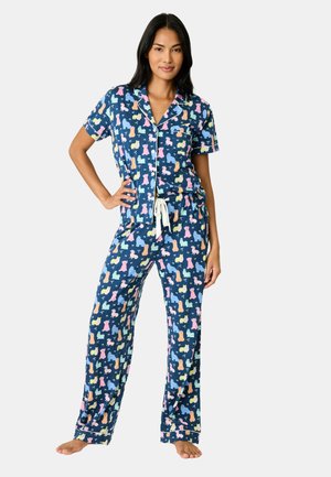 Navy blue pajama set with short sleeves and drawstring pants, featuring colorful animal silhouettes and white piping accents.
