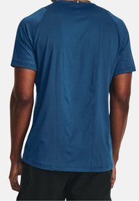 Navy blue athletic t-shirt with a textured panel design on back, short sleeves, and a round neck, made from moisture-wicking material.