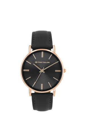 Tom Tailor wristwatch with black leather strap, black dial, gold-tone case, and gold hour markers and hands showing 10:09:38.