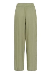 Pantalon ample de couleur vert olive clair avec taille élastique et poches latérales, présenté sur un fond blanc.