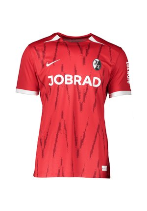 Rød kortærmet fodboldtrøje med hvide kravekanter, subtilt mørkere rødt mønster, JOBRAD-logo, Nike-swoosh og holdbadge på brystet.