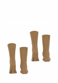 Beżowe skarpetki bawełniane z prążkowaną teksturą, długość do połowy łydki, z logo na podeszwie i minimalistycznym wykończeniem. Zestaw czterech par.