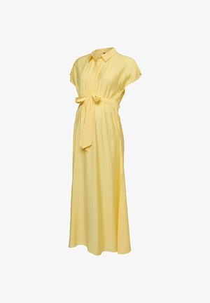 Gele zwangerschapsjurk met korte mouwen, kraag, knopen aan de voorkant en een tailleband, vallend tot enkellengte.