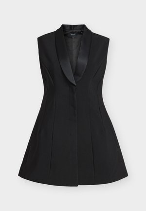 Black sleeveless vest with a satin shawl collar, tailored fit, flared hem, and structured seams for a polished look.