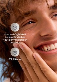 Skincare product with a textured surface. Key features: dermatologically confirmed for sensitive skin, alcohol-free. Smooth, natural tones visible.