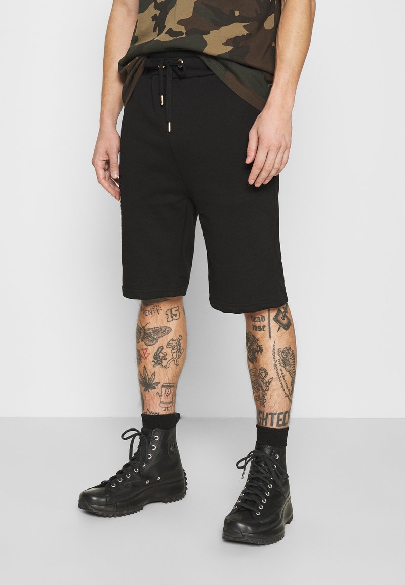 Alpha Industries - BASIC FOIL PRINT - Pantaloni sportivi - black/yellow gold, Ingrandire